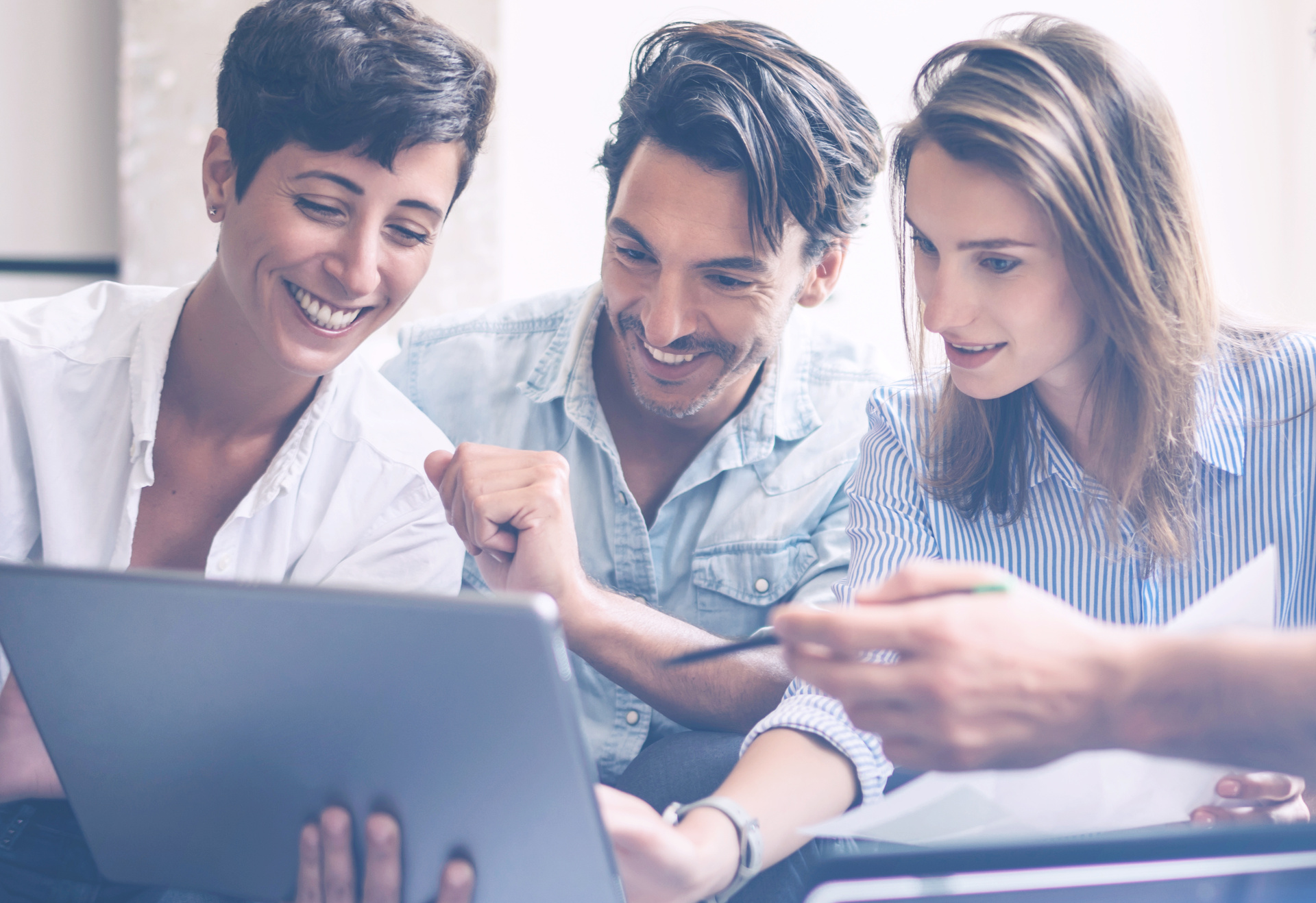 Teamwork process.Young entrepreneur work with new startup project in office.Woman holding touch pad in hands.Horizontal, blurred, flare